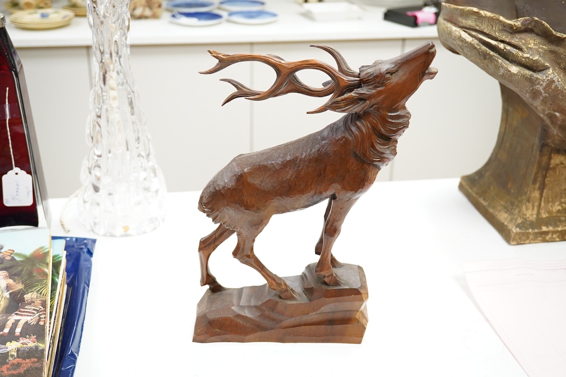 A Swiss Black Forest carving of a roaring stag, 34cm high